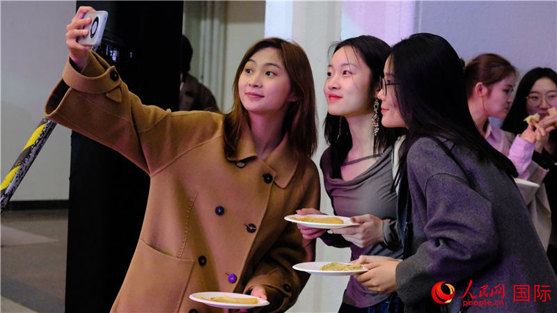 中國觀眾在現(xiàn)場品嘗“謝肉節(jié)”節(jié)日美食——煎薄餅。人民網(wǎng) 褚夢琦攝