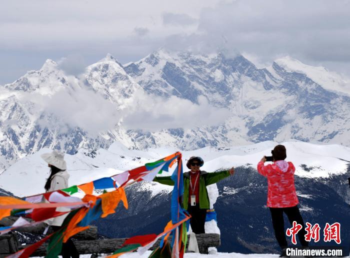 圖為5月14日，西藏林芝色季拉山觀景臺(tái)，游客與南迦巴瓦峰合影?！±盍?攝